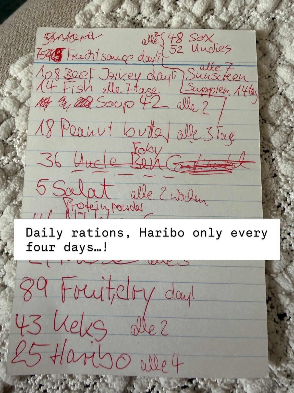 Handwritten daily ration ledger in red ink