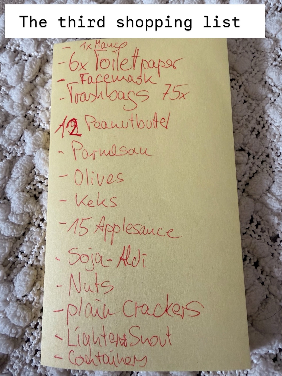 Handwritten shopping list in red ink