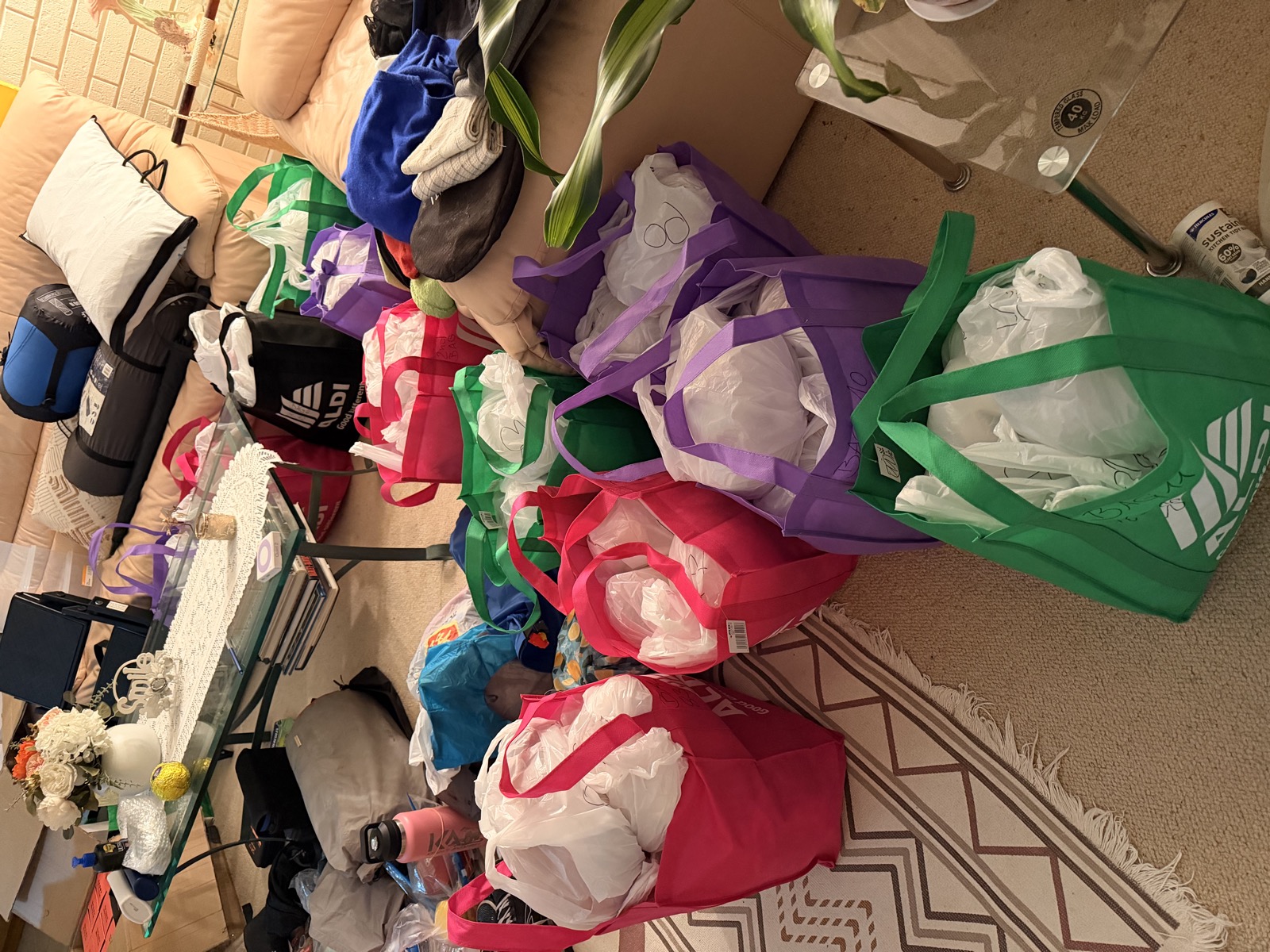 A floor covered in colour-coded shopping bags