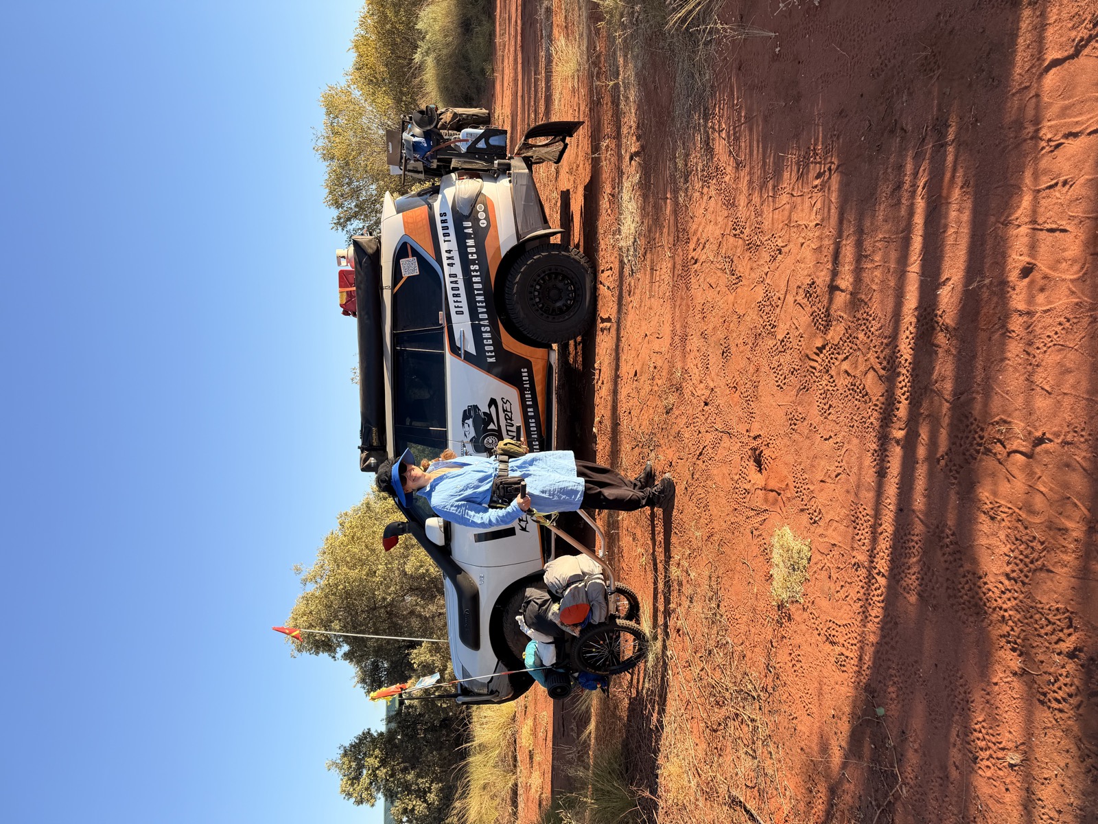 The support vehicle on the track with an orange flag