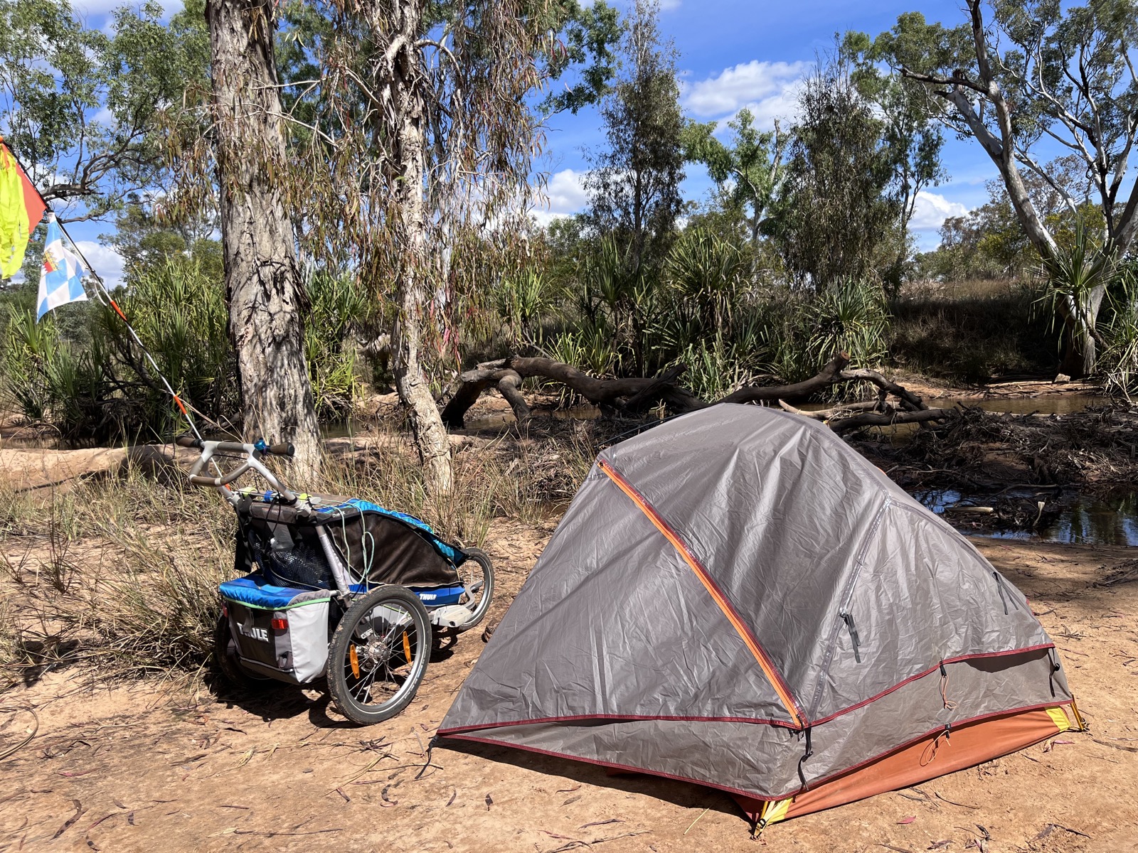 A tent pitched beside a creek